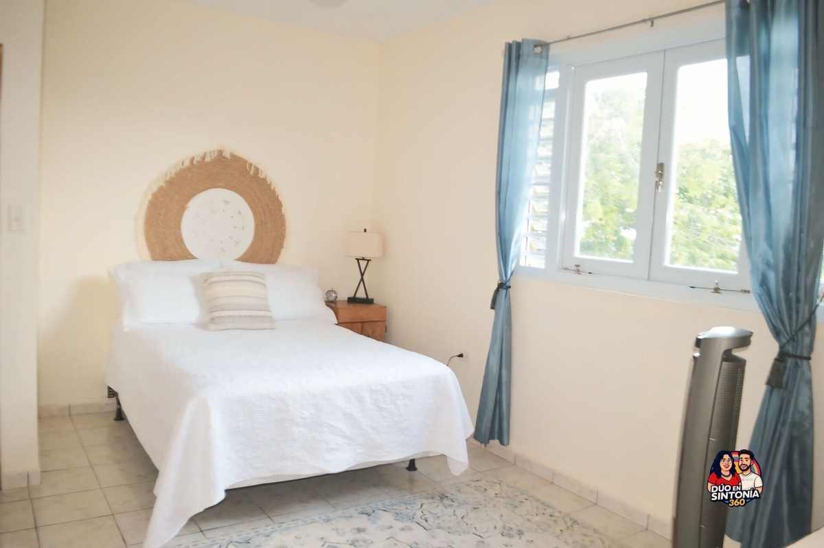 Bedroom in white linens with garden window