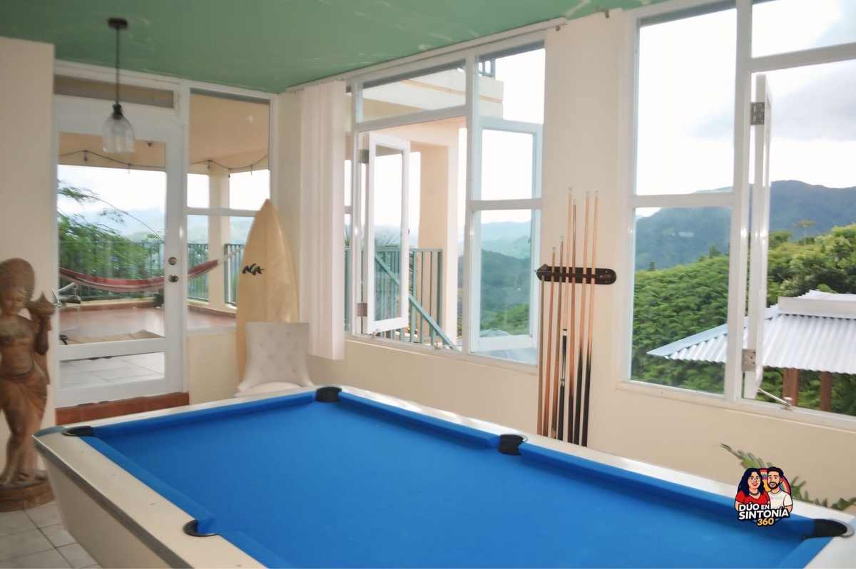 Game room with billiards table and mountain windows