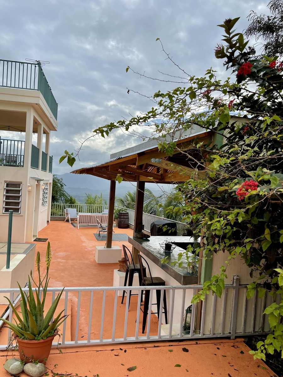 Pool deck and pavilion overlooking the green mountain valley