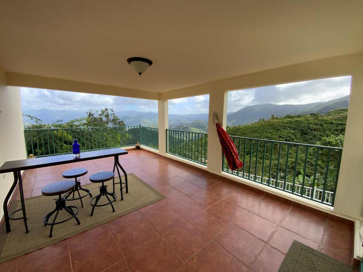 Tiled veranda with cafe table facing the mountains